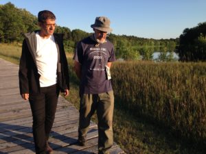 Alberto and Robert on the boardwalk along the Mississippi River at the Crow Wing Park Town Site, 2019