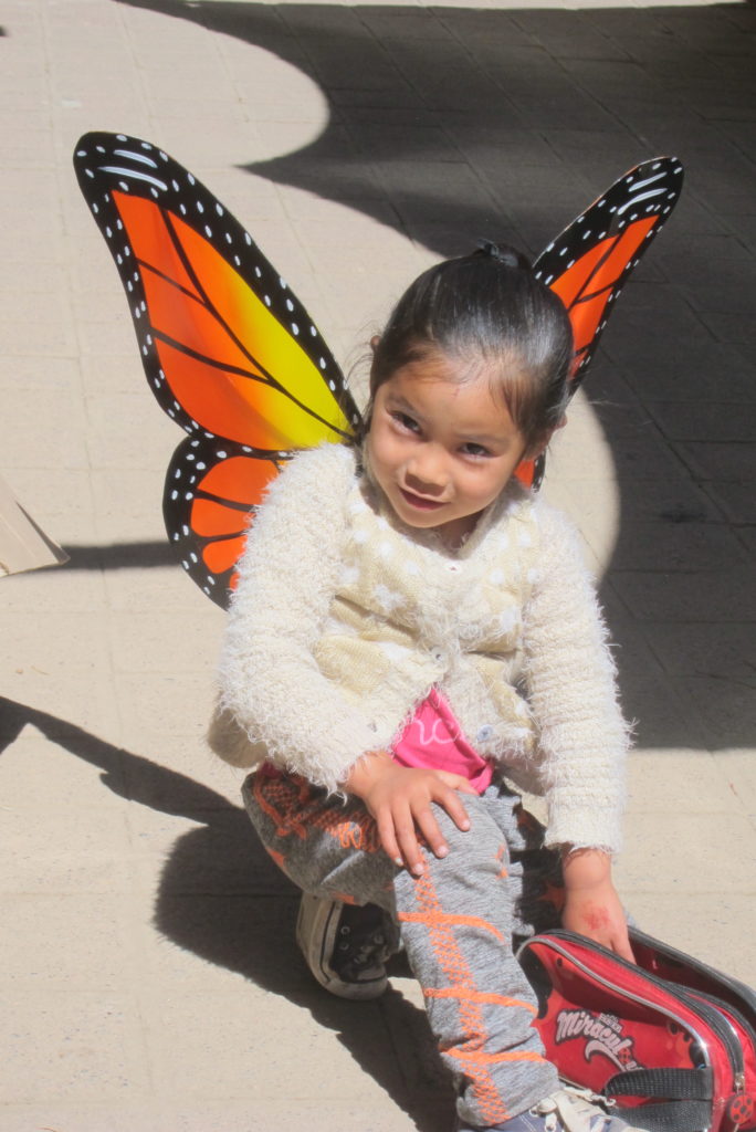 Daughter of a vendor at the Monarch Sanctuary modeling her wings